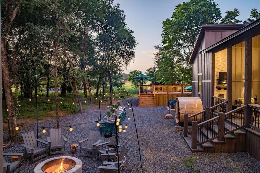 Aerial view of a cabin with pool and stargazing dome in the pines
