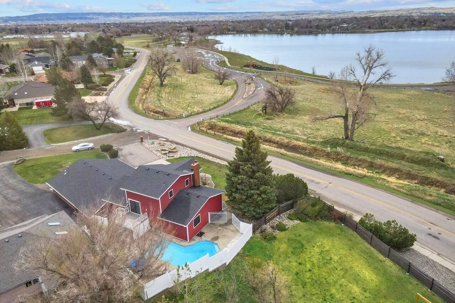 Aerial view of a lakefront home with backyard pool