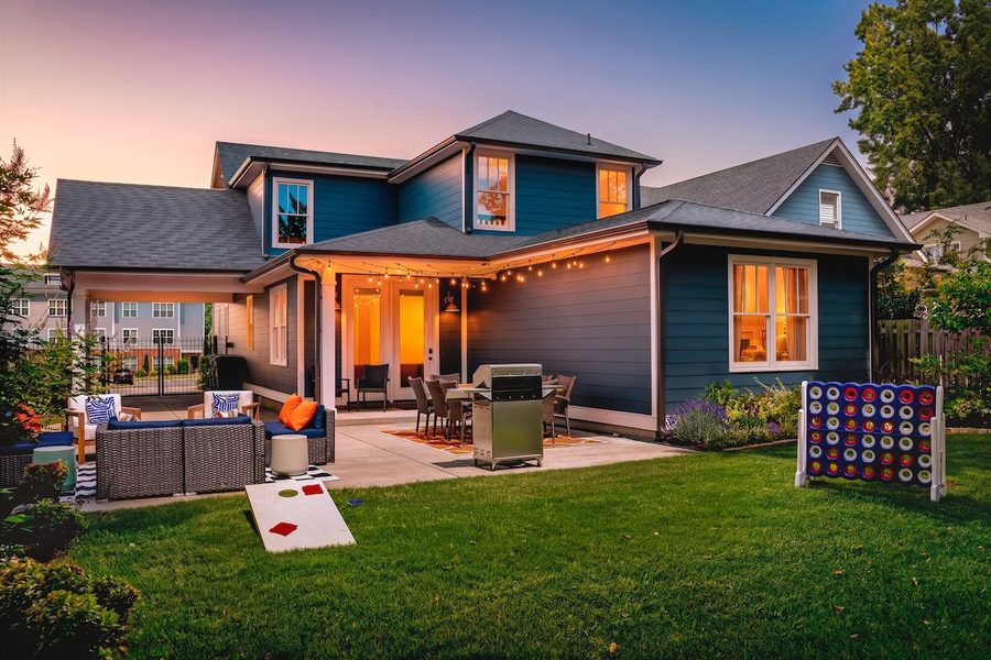 Front of a blue craftsman home at dusk