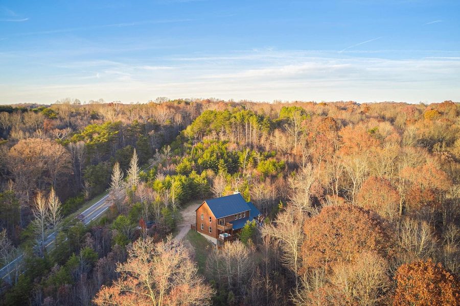 Aerial view of cabin in fall forest
