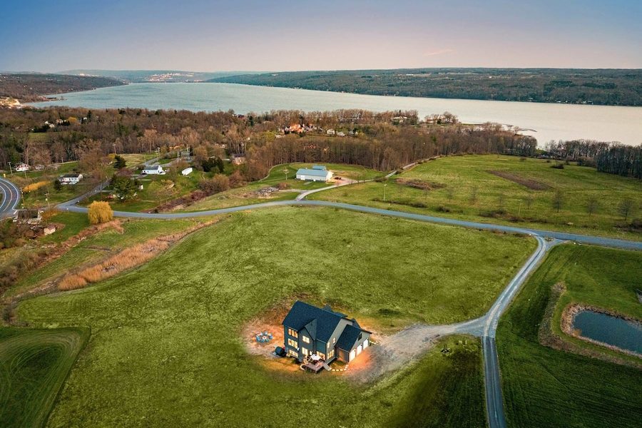 Aerial view of waterfront property and yard